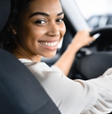 A happy woman driving a car