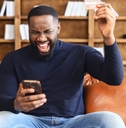 Adult man using phone apps to earn gift cards