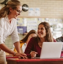 high school professor helping student in class