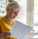 senior woman filling out financial statements