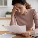 stressed millennial female freelancer scratching forehead