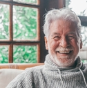 old man smiling and looking at the camera