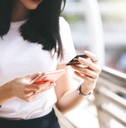 female consumer using credit card and smartphone