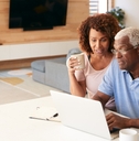 senior couple using laptop to check finances