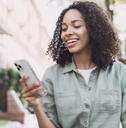 Woman smiling and looking at phone