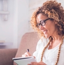A middle-aged woman looking at computer