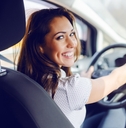 Woman in driver&#x27;s seat smiling