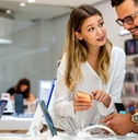 young people buying new smartphone in mobile shop