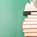 hardback books on wooden table