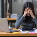 tired young woman working on documents
