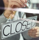 young woman hanging banner with closed word