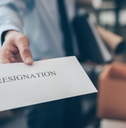 businessman showing resignation letter to employer boss