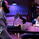 Two podcasters in a semi-dark room