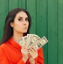 woman in red formal shirt holding money in hand 