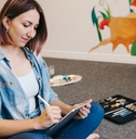 female artist drawing on a touch pad digital tablet