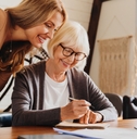 investment advisor consulting with retired woman at home