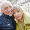 Smiling retired couple wearing winter jackets