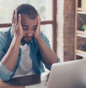 Man frustrated looking at computer