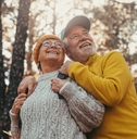 middle age cheerful people smiling and looking at the the trees 