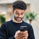 Man looking at phone and smiling