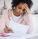 woman calculating debts feeling stressed