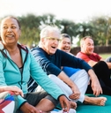 multi-ethnic seniors doing yoga in park