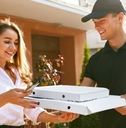 man delivering a pizza to a woman