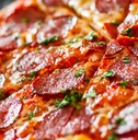 pepperoni pizza with cheese and tomato sauce, topped with aromatic basil leaves