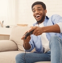 young man playing video games at home
