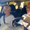 Older couple driving car