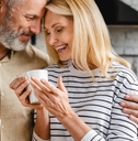 affectionate mature couple enjoying cup of coffee