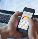 man holding smartphone showing credit score