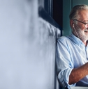 elderly man watching online movie from his phone