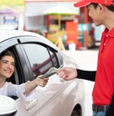 worker receiving money from driver customer