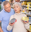 husband and wife choose canned food together