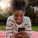 Happy woman looking at phone