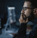 man coding on computer late at night