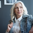 charming positive senior woman is relaxing on sofa