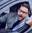 Man leaning out of car window yelling