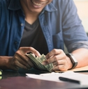hands of young businessman counting money