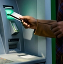 woman using atm late at night