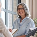 female hr manager standing in front of young female assistant at office