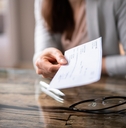 businessperson&#x27;s hand holding cheque