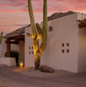 arizona resort under orange sky with cute cactus plant at sunset