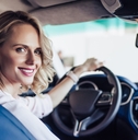 smiling woman sitting in the car