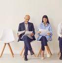 candidates sitting on chairs waiting for job interview