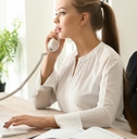 female secretary talking on telephone in office