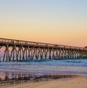 myrtle beach ocean pier with coastal tides at sunset 