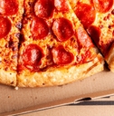 close up of &#x27;Costco food court&quot; delicious fresh made pepperoni pizza sliced and placed in cardboard box
