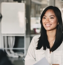 woman smiling and holding resume